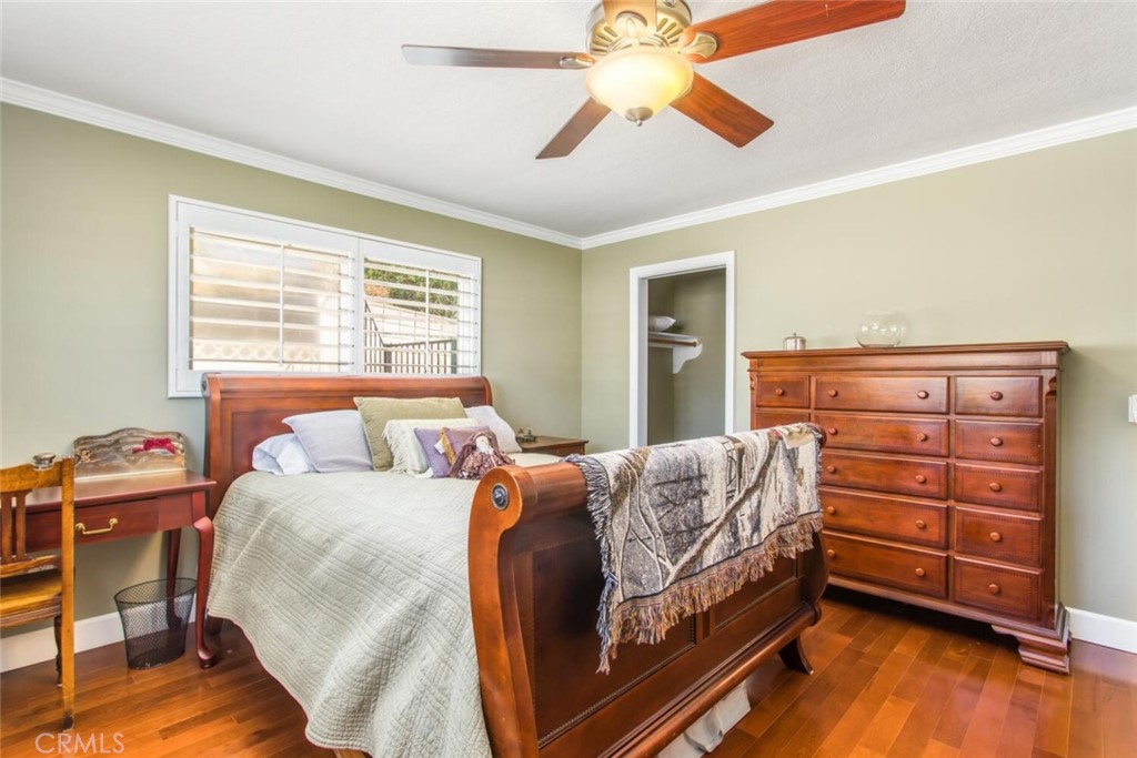 35893 Cornell Drive Yucaipa, CA 92399 - Photo 25 of 39 a bedroom with a bed and a chandelier