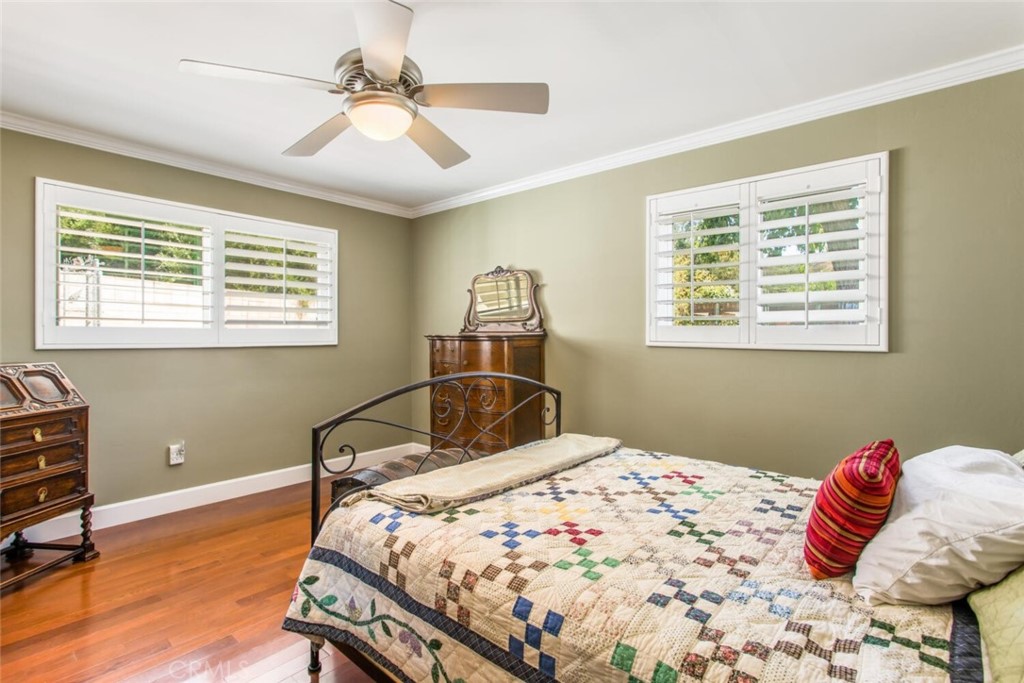 35893 Cornell Drive Yucaipa, CA 92399 - Photo 28 of 39 a bedroom with a bed and a chandelier