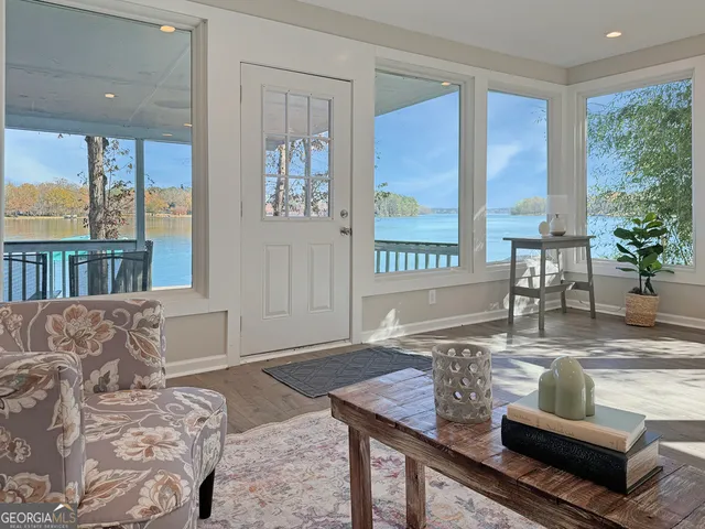 a large white kitchen with cabinets and wooden floor