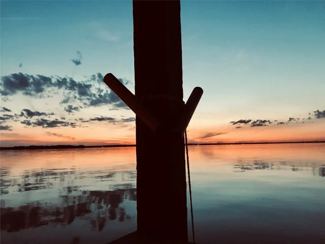 a view of a lake with a wooden bridge