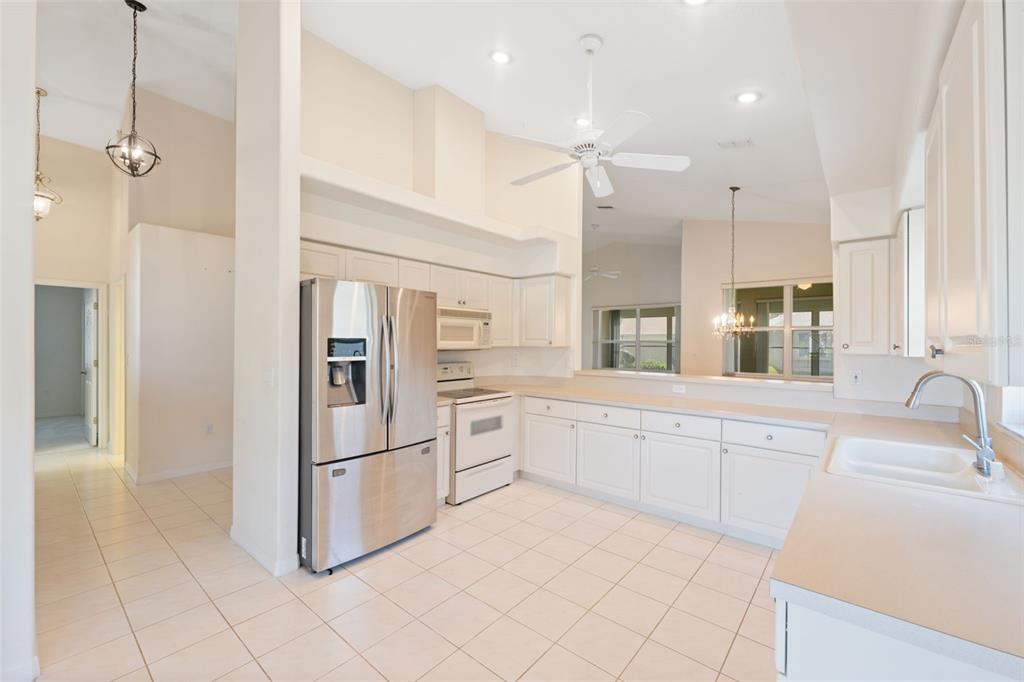 10149 Duffy Circle Weeki Wachee, FL 34613 - Photo 15 of 59 a kitchen with granite countertop white cabinets and stainless steel appliances