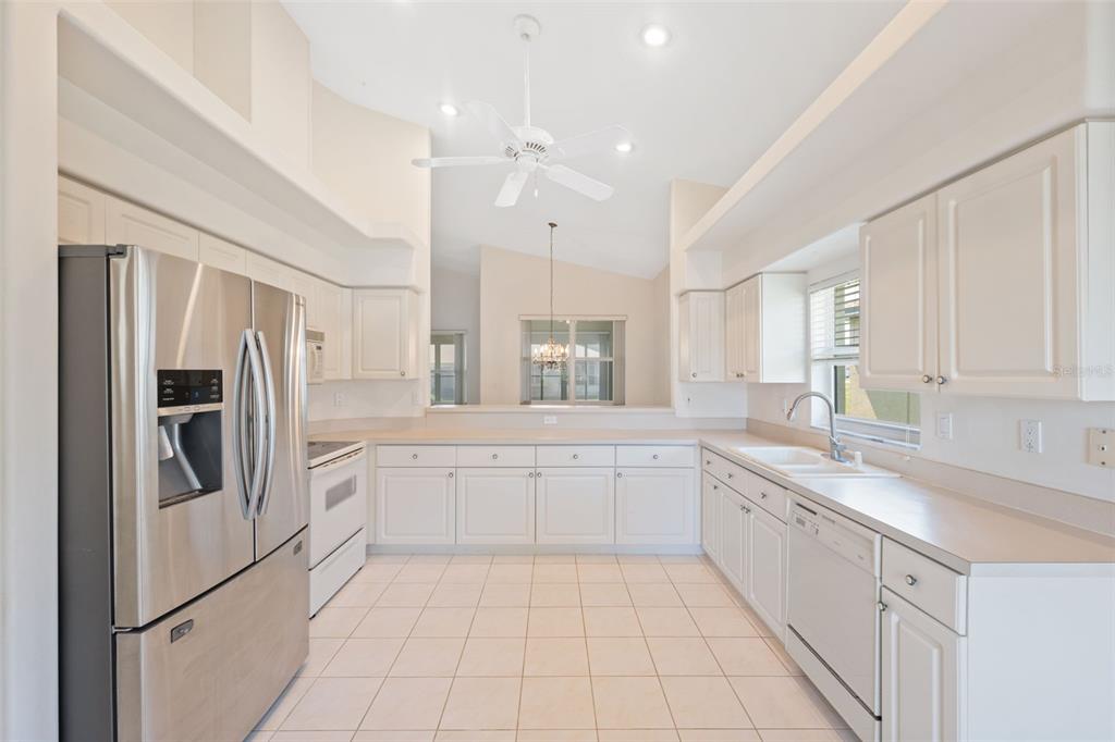 10149 Duffy Circle Weeki Wachee, FL 34613 - Photo 16 of 59 a large white kitchen with cabinets and stainless steel appliances