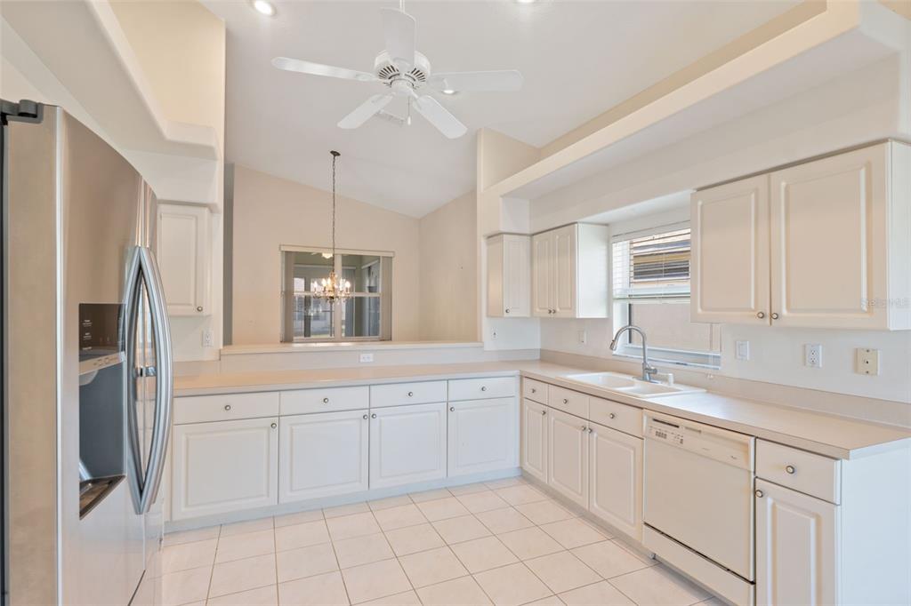 10149 Duffy Circle Weeki Wachee, FL 34613 - Photo 17 of 59 a kitchen with white cabinets and white appliances