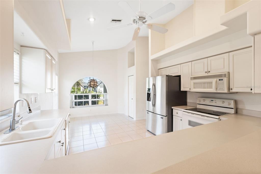 10149 Duffy Circle Weeki Wachee, FL 34613 - Photo 20 of 59 a kitchen with stainless steel appliances a stove sink and microwave