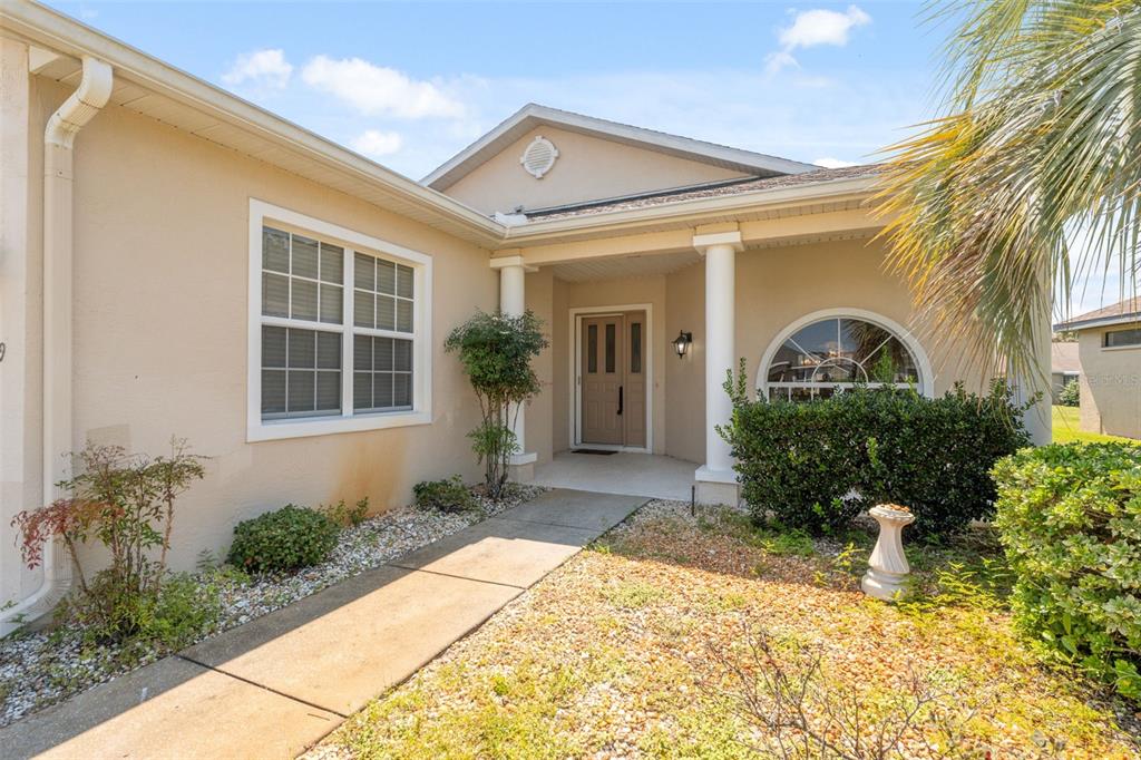 10149 Duffy Circle Weeki Wachee, FL 34613 - Photo 3 of 59 a front view of a house with a yard and potted plants