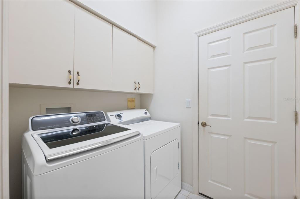 10149 Duffy Circle Weeki Wachee, FL 34613 - Photo 31 of 59 a utility room with dryer and washer
