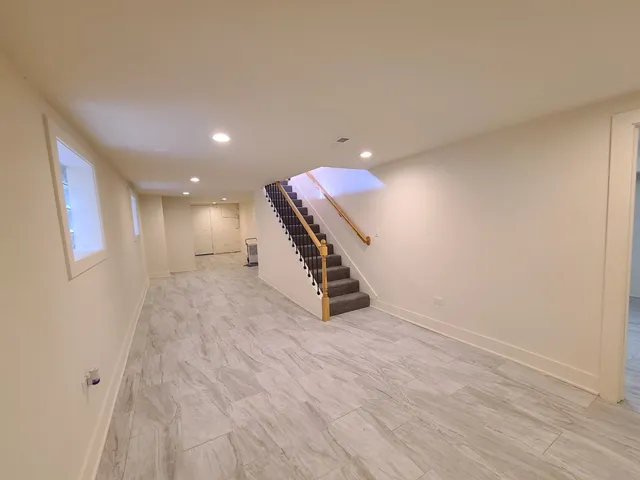 an entryway in hall with wooden floor