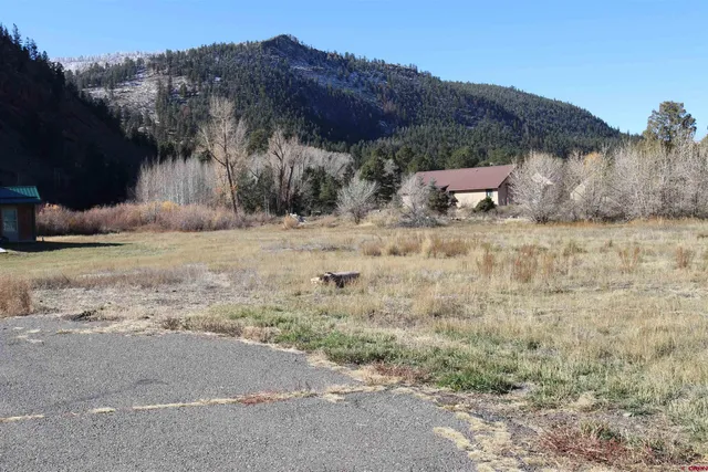 a view of a dry yard with a barn