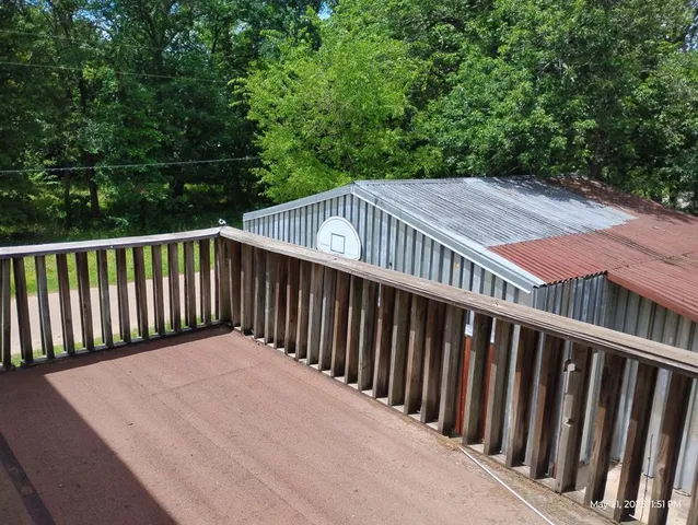 a balcony with trees in front of it