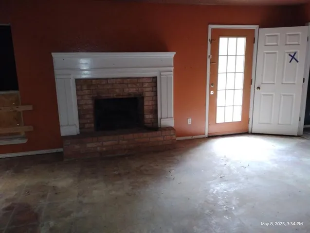 a view of empty room with a fireplace