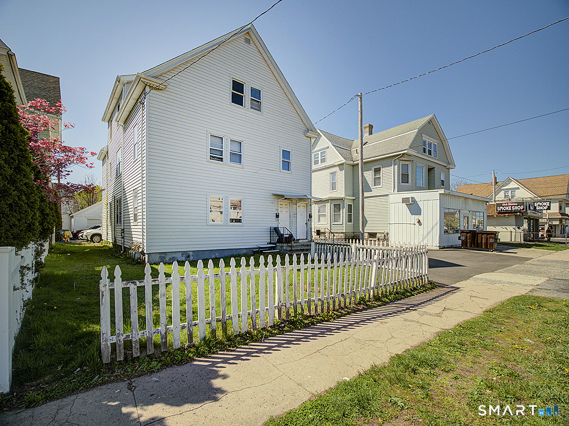 1052 Dixwell Avenue Hamden, CT 06514 - Photo 2 of 25 a front view of a house with a garden