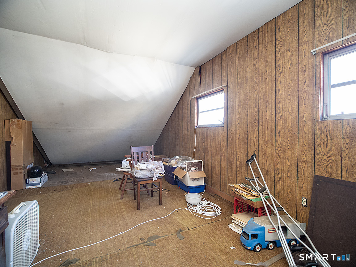 1052 Dixwell Avenue Hamden, CT 06514 - Photo 23 of 25 a bedroom with furniture and a window