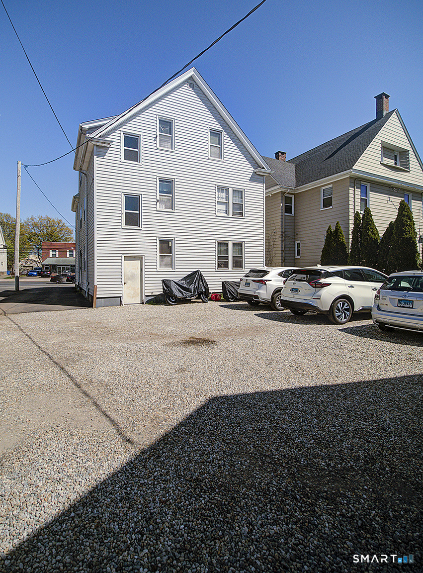 1052 Dixwell Avenue Hamden, CT 06514 - Photo 3 of 25 a view of car parked in front of house