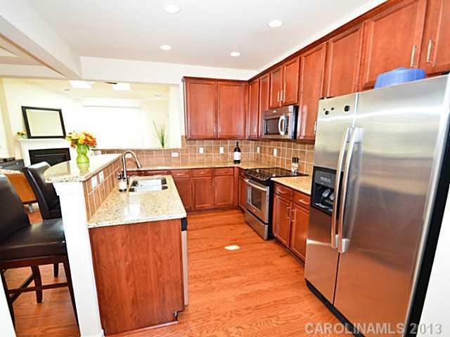 7120 Maricopa Road Charlotte, NC 28277 - Photo 3 of 16 a kitchen with stainless steel appliances granite countertop a refrigerator a stove top oven a sink and dishwasher