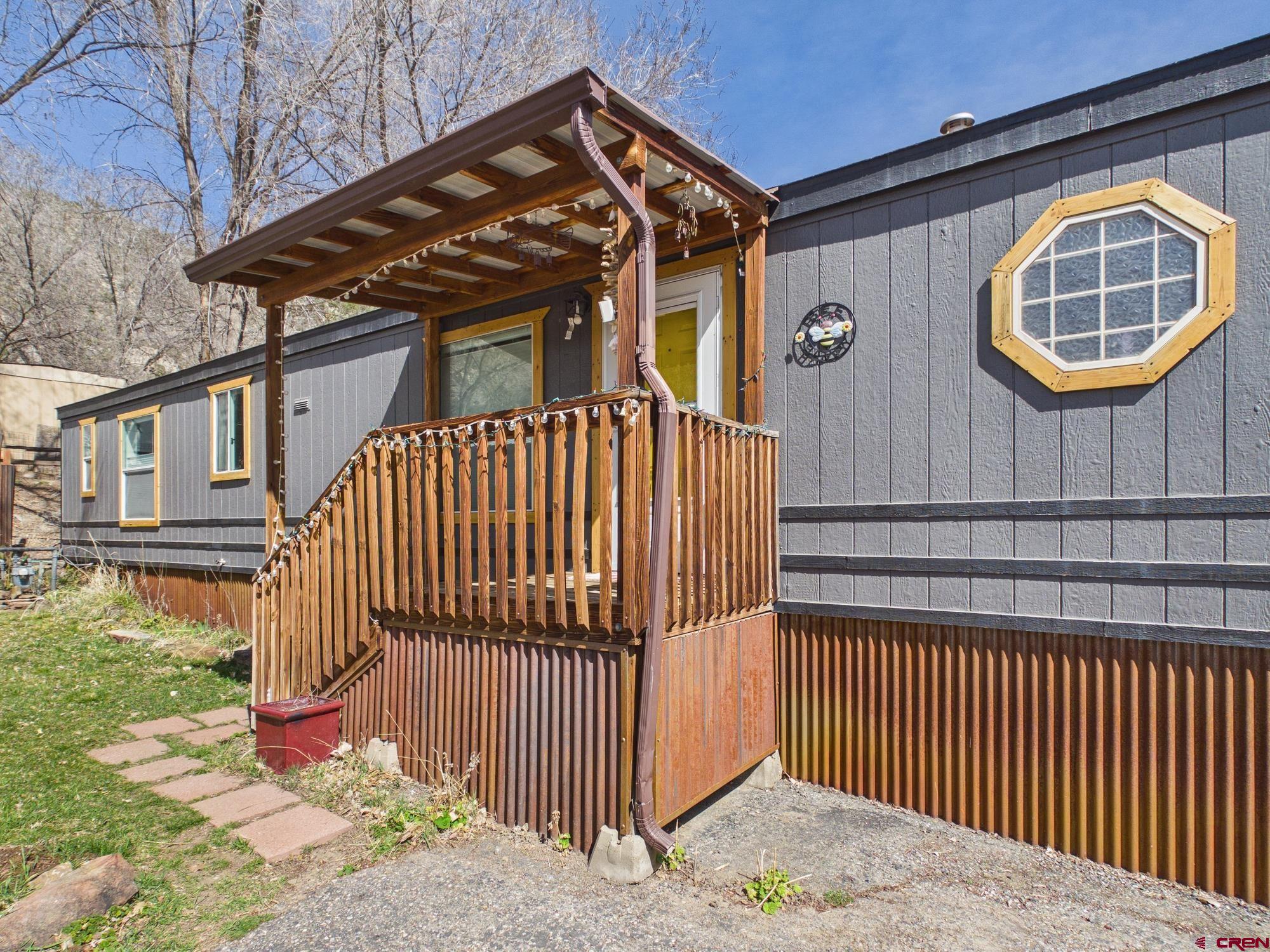 a view of a brick house with wooden fence