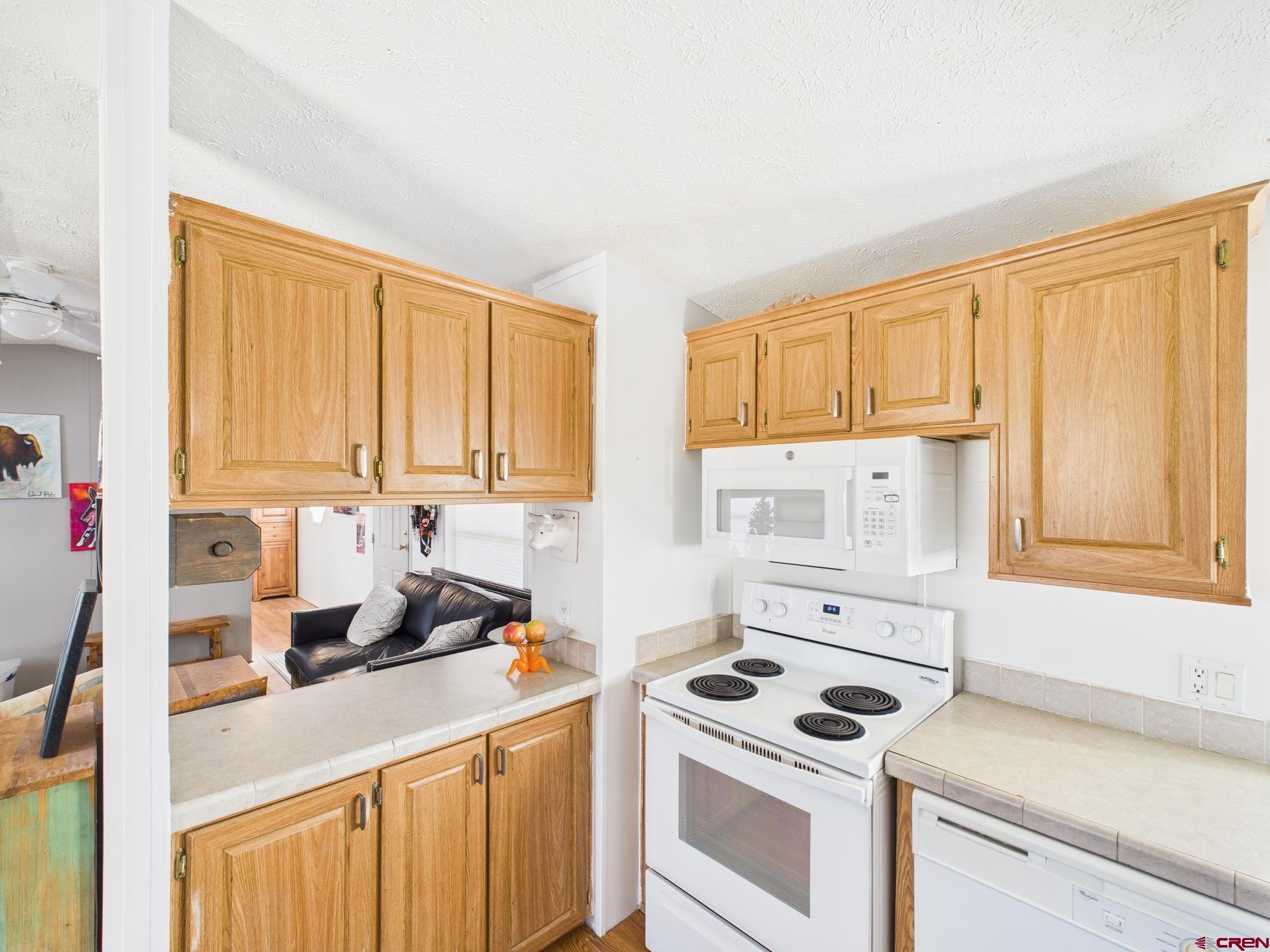 288 Animas View Drive, Unit 9 Durango, CO 81301 - Photo 7 of 20 a kitchen with a sink stove top oven and cabinets