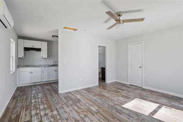 a view of a kitchen with wooden floor and a sink