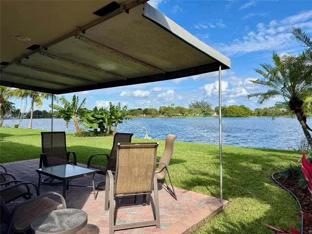 a view of a house with a backyard porch and sitting area