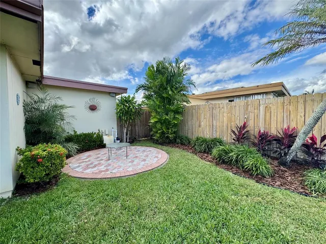 a view of a house with a backyard porch and sitting area