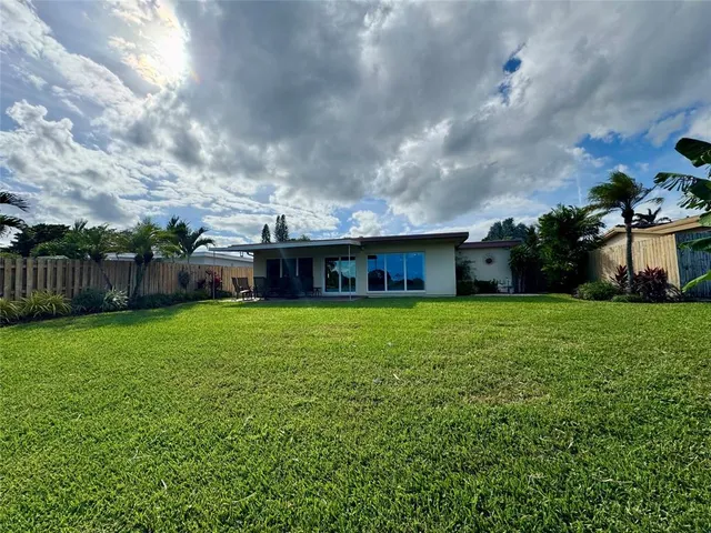 a view of backyard of house and entertaining space