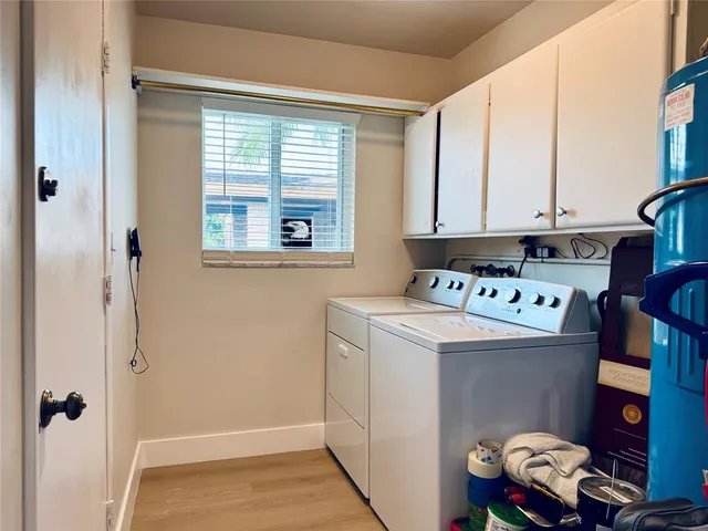 an aerial view of residential houses with outdoor space and lake view