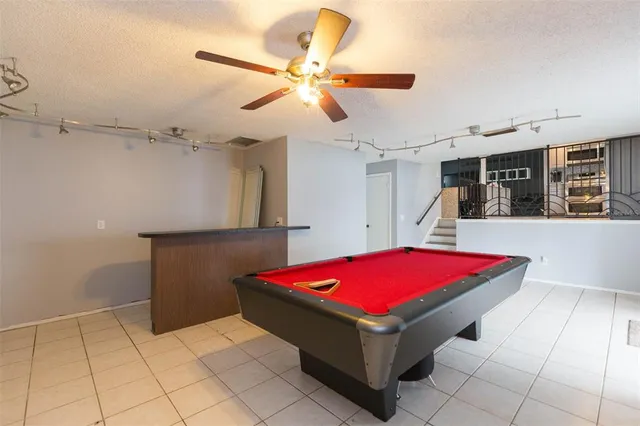 a room with pool table and a chandelier