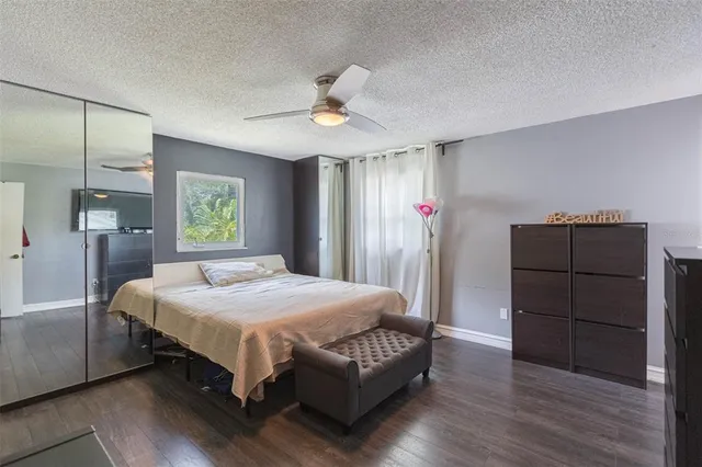 a bedroom with a bed window and dresser