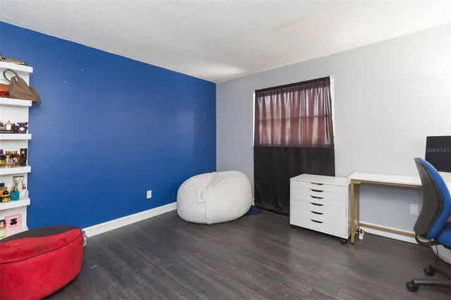 a view of workspace with furniture and wooden floor
