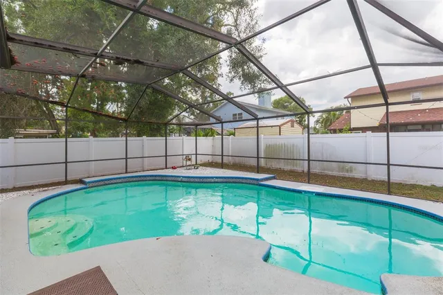 a swimming pool with outdoor seating