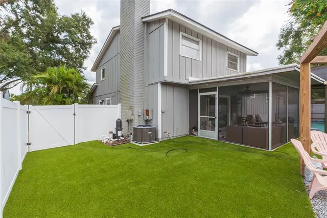 a backyard of a house with table and chairs