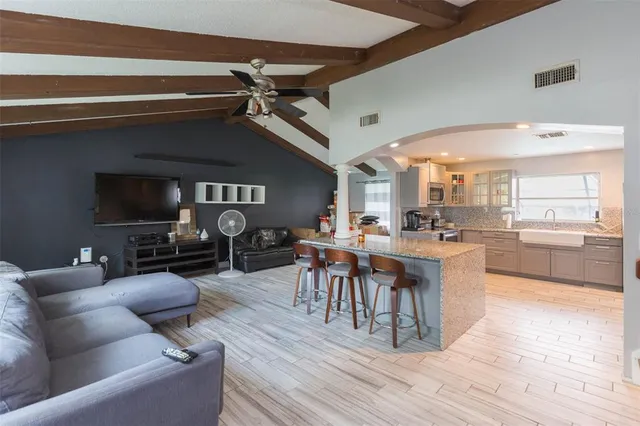 a living room with furniture a rug and a fireplace