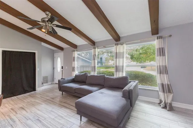 a living room with furniture and a floor to ceiling window