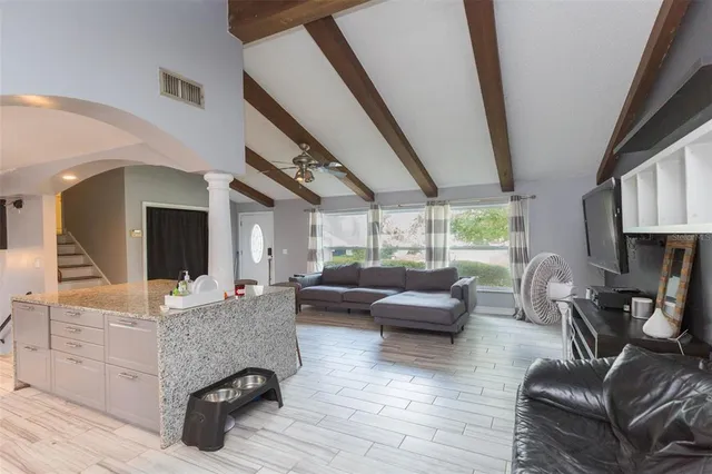 a living room with furniture and a large window