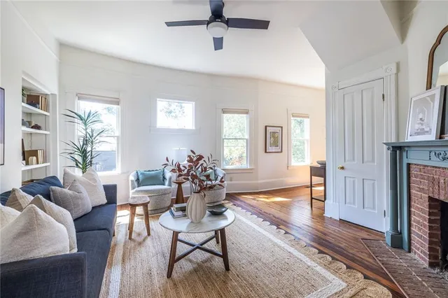 a living room with fireplace furniture and a wooden floor