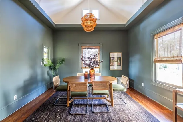 a dining room with furniture a rug and a chandelier