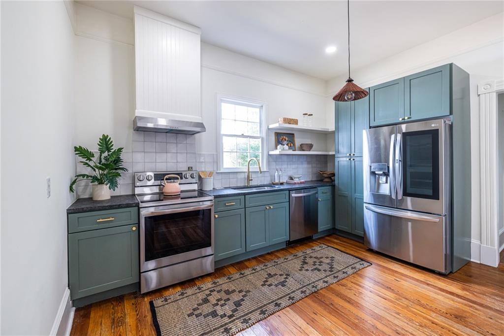 532 Broyles Street Southeast Atlanta, GA 30312 - Photo 16 of 37 a kitchen with stainless steel appliances kitchen island granite countertop a sink stove and refrigerator