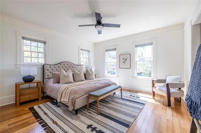 a bedroom with a bed and wooden floor