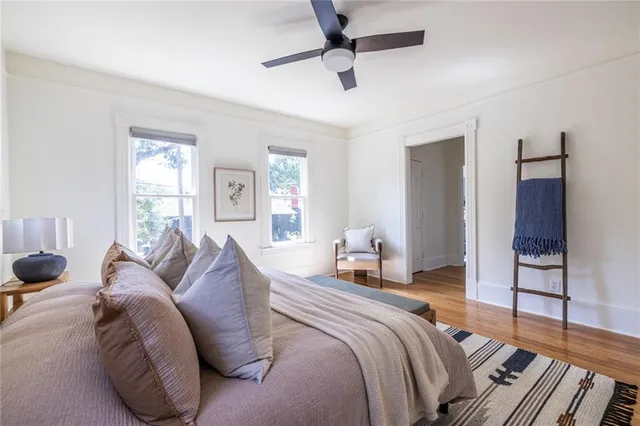 a bedroom with a bed and wooden floor