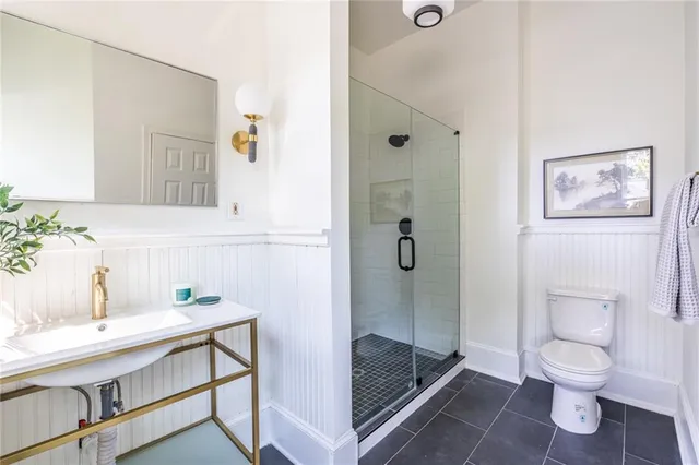 a bathroom with a sink toilet and shower
