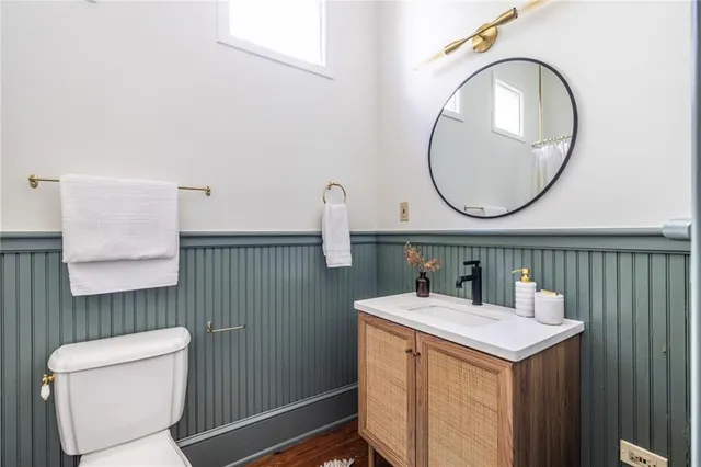 a bathroom with a sink a toilet and a mirror