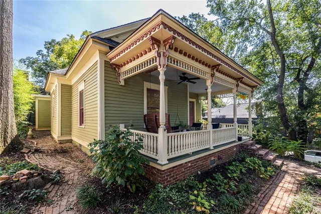 a view of a house with large windows and a small yard
