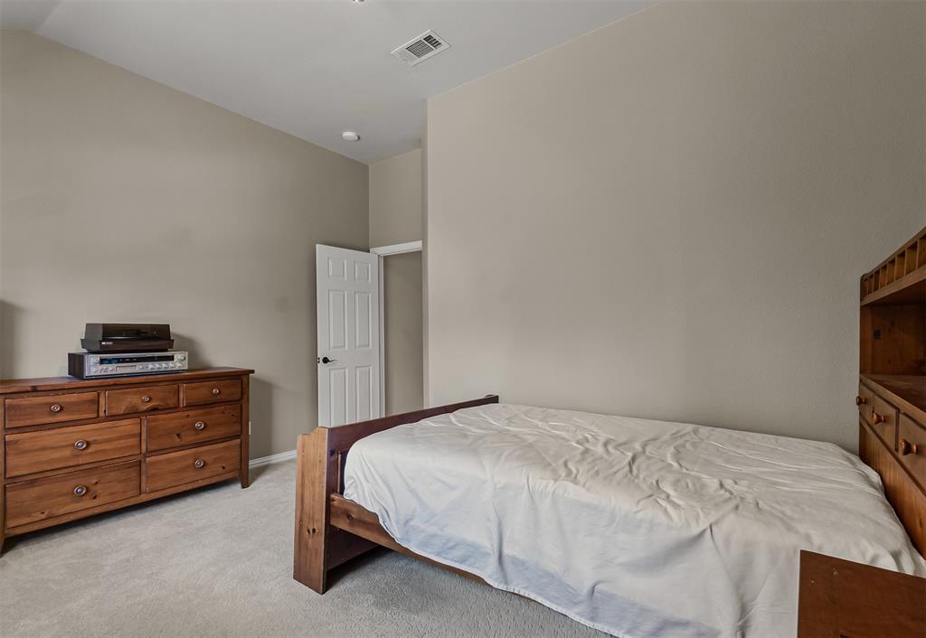 9301 Nottingham Court Rowlett, TX 75088 - Photo 18 of 39 Carpeted room with vaulted ceilings and neutral wall tones