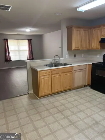 a kitchen with stainless steel appliances granite countertop a sink and cabinets