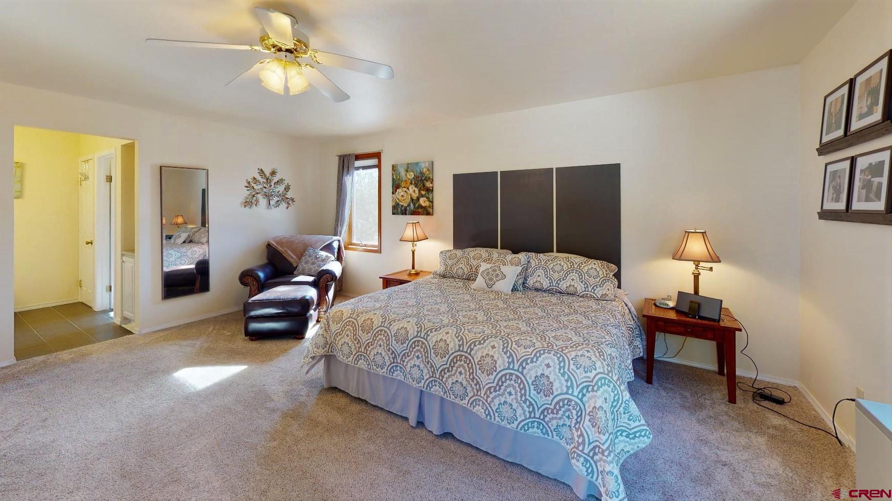 84 Ridge Road Durango, CO 81303 - Photo 13 of 33 a bedroom with bed and a chandelier