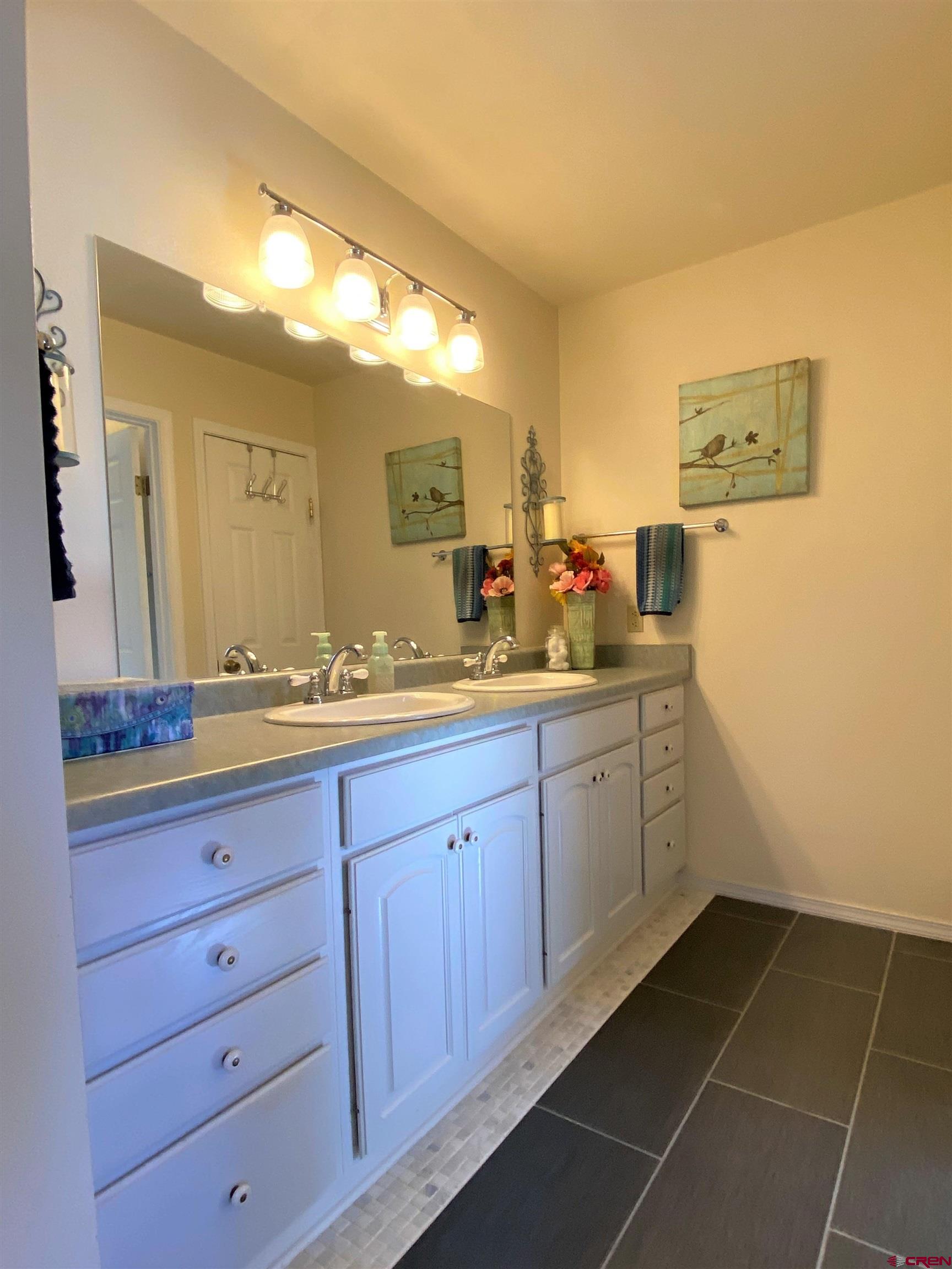 84 Ridge Road Durango, CO 81303 - Photo 14 of 33 a spacious bathroom with a granite countertop sink and a mirror