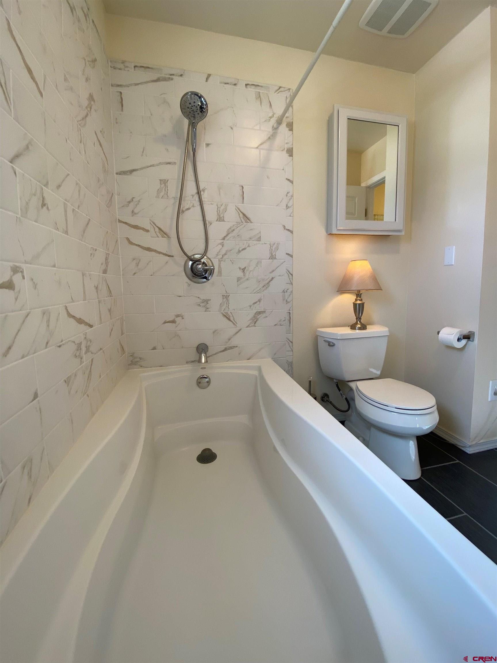 84 Ridge Road Durango, CO 81303 - Photo 16 of 33 a bathroom with a granite countertop toilet a sink and bathtub