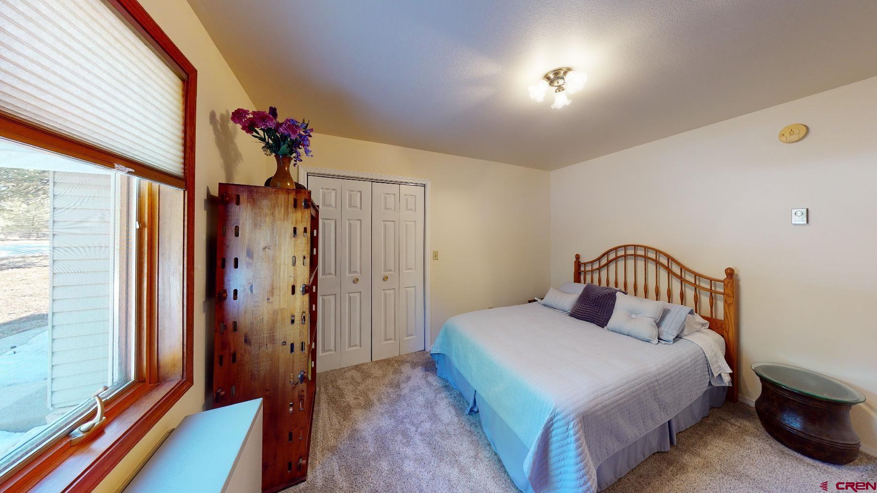 84 Ridge Road Durango, CO 81303 - Photo 18 of 33 a bedroom with a bed and a potted plant
