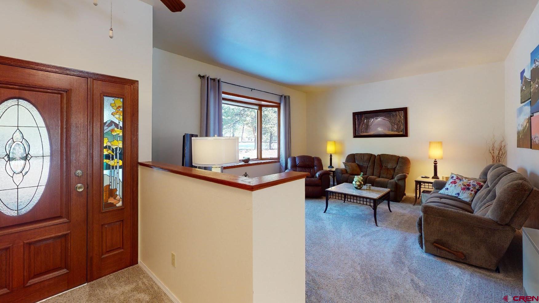 84 Ridge Road Durango, CO 81303 - Photo 2 of 33 a living room with furniture a window and a fireplace