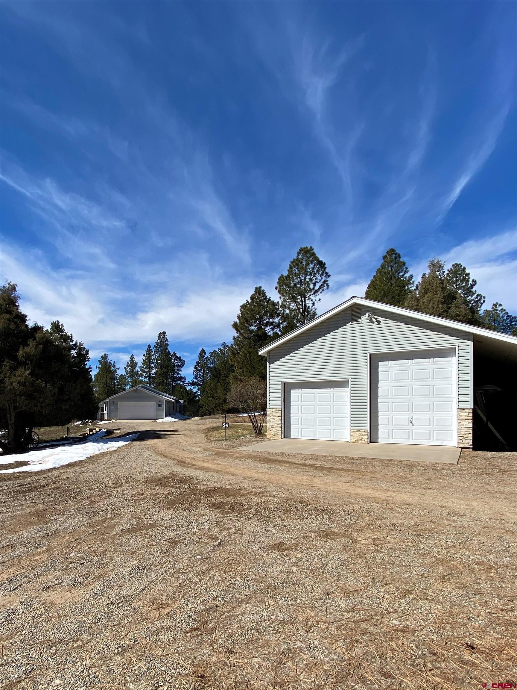 84 Ridge Road Durango, CO 81303 - Photo 23 of 33 a view of house with a yard and a large tree