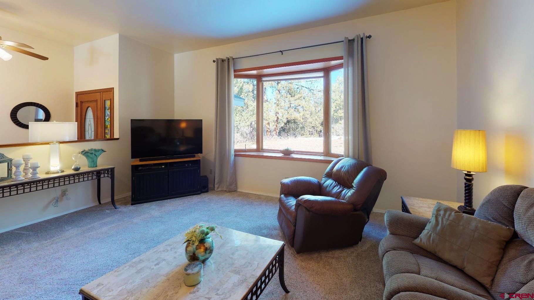 84 Ridge Road Durango, CO 81303 - Photo 3 of 33 a living room with furniture and a flat screen tv